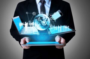Infinity Tech Consulting professional holding tablet displaying connected devices global network and digital workforce silhouettes in GA